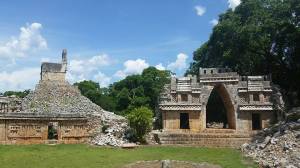 The triumphal arch and unrestored pyramid at Labna